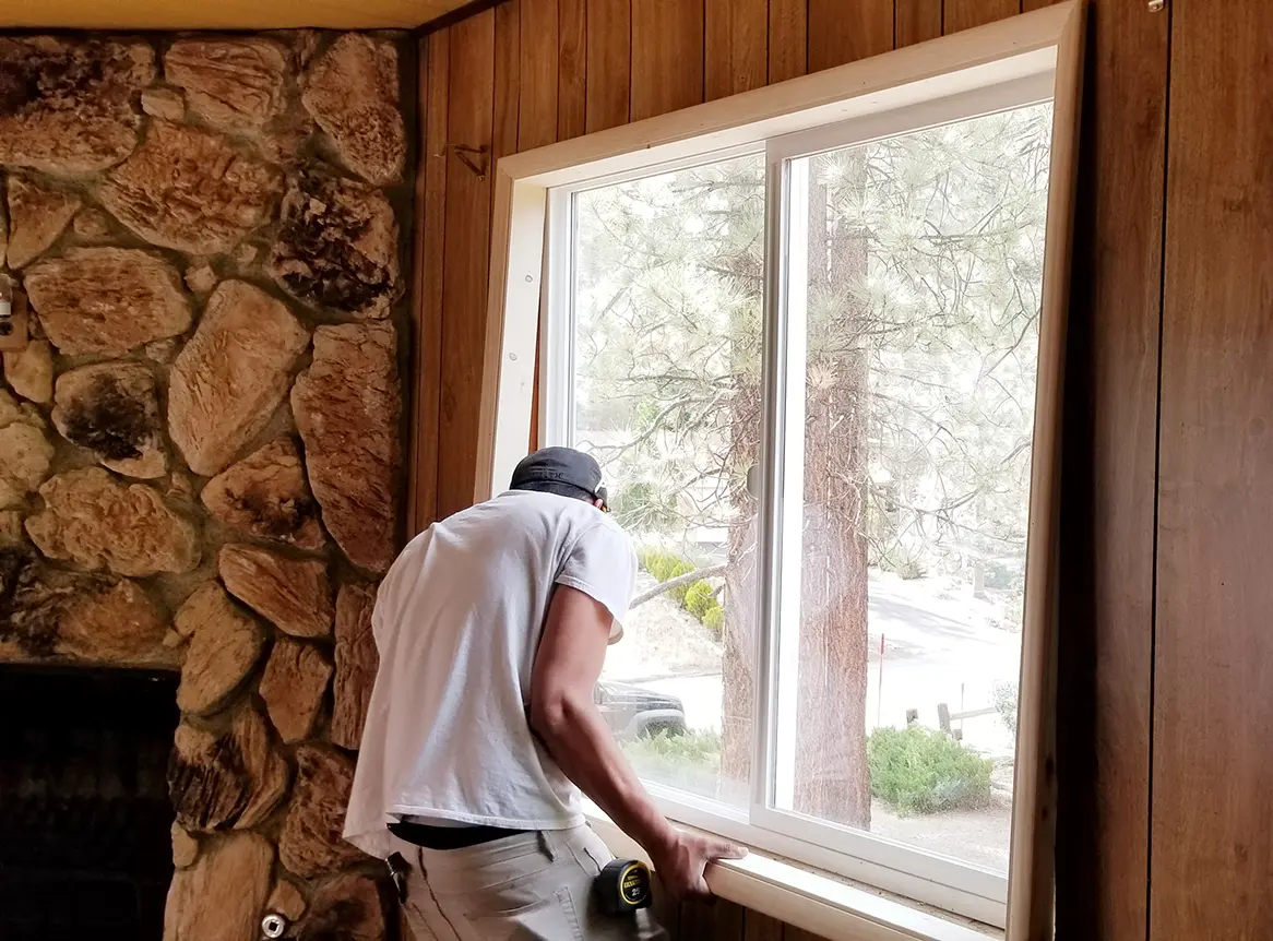 builder putting in new windows in a house